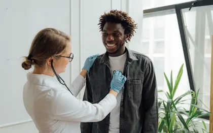 A nurse listening to a patient's chest