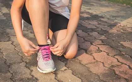 Someone lacing up walking shoes